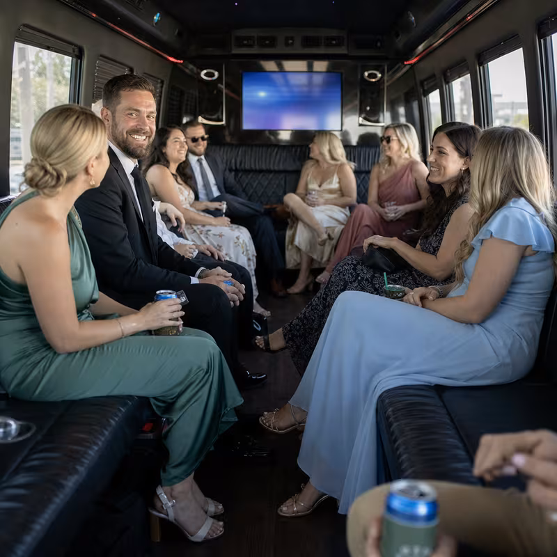 Wedding guests seated inside a Mobile party bus