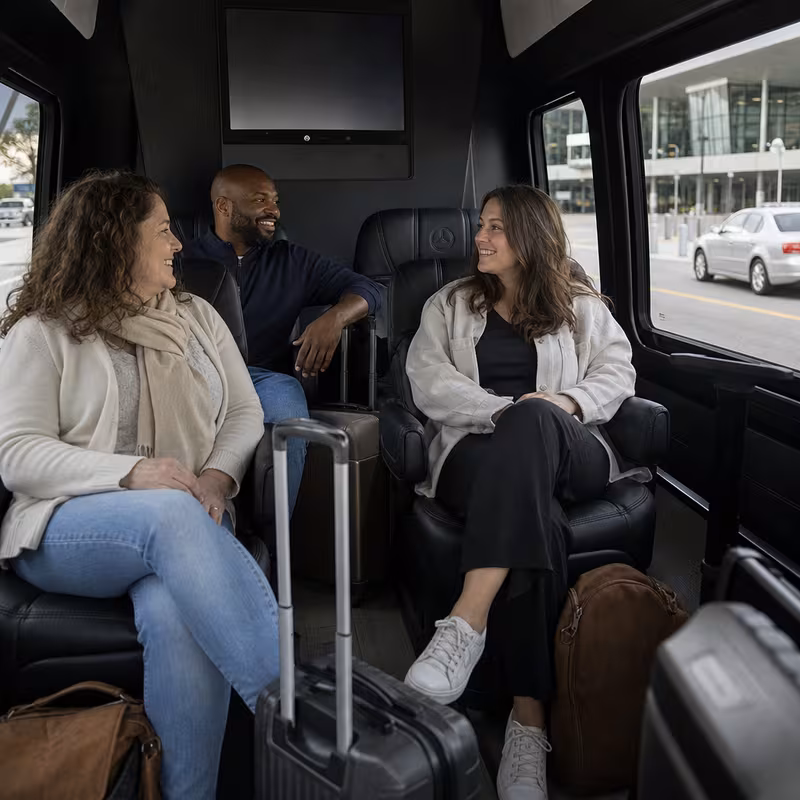 Passengers loading luggage while boarding an Mobile group shuttle