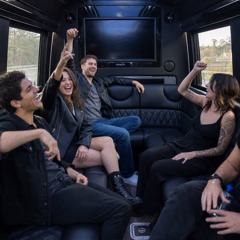 Group boarding a white charter bus for Concert Transportation transportation in Mobile