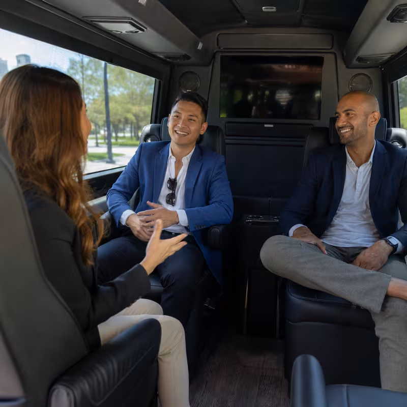 Group boarding a white charter bus for Corporate Transportation transportation in Mobile