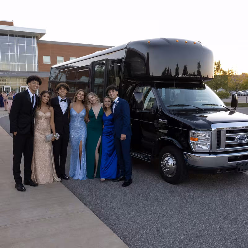 Group boarding a white charter bus for Prom & Homecoming Transportation transportation in Mobile