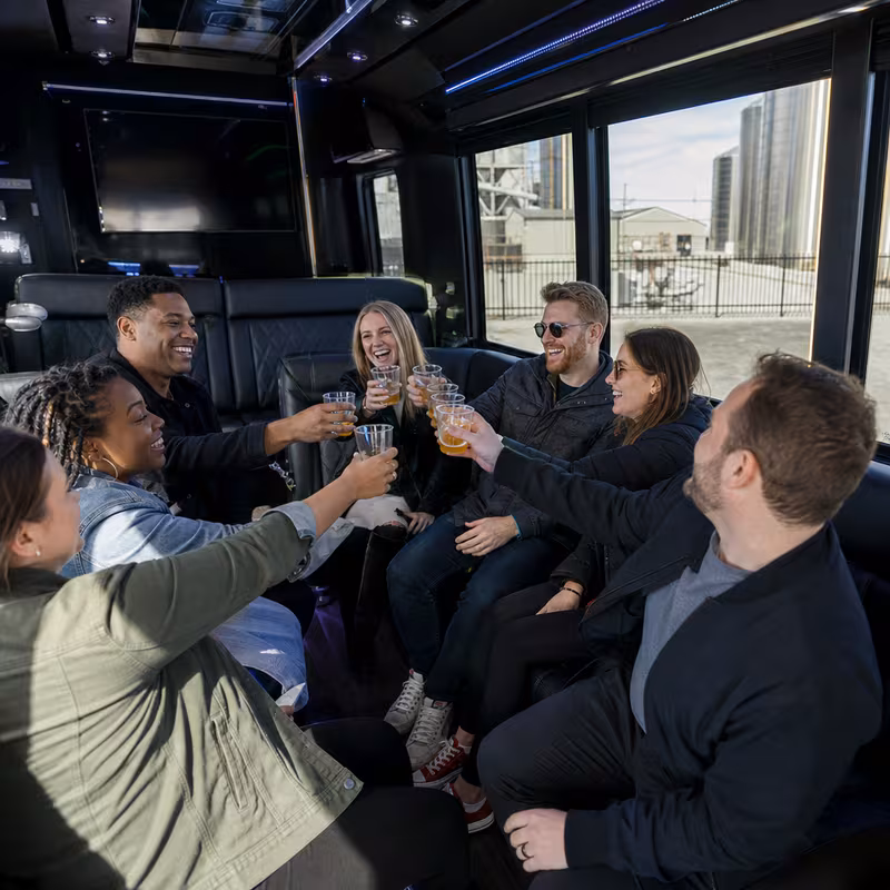 Group boarding a white charter bus for Winery & Brewery Tour Transportation transportation in Mobile