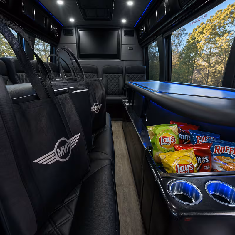 Party bus interior with wraparound leather seating and LED lighting in Mobile